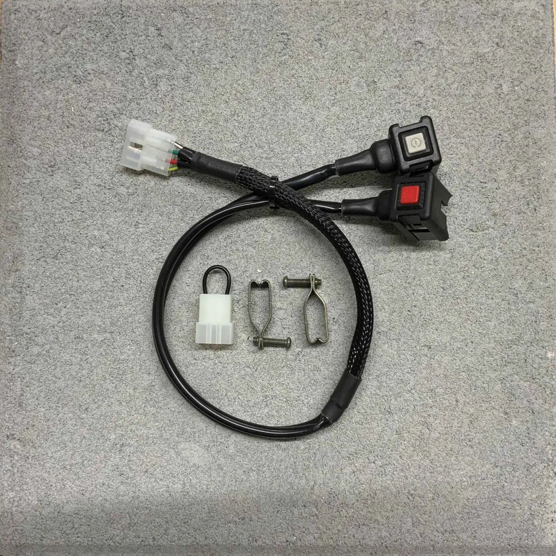 Wiring harness with connectors and switches on a gray surface